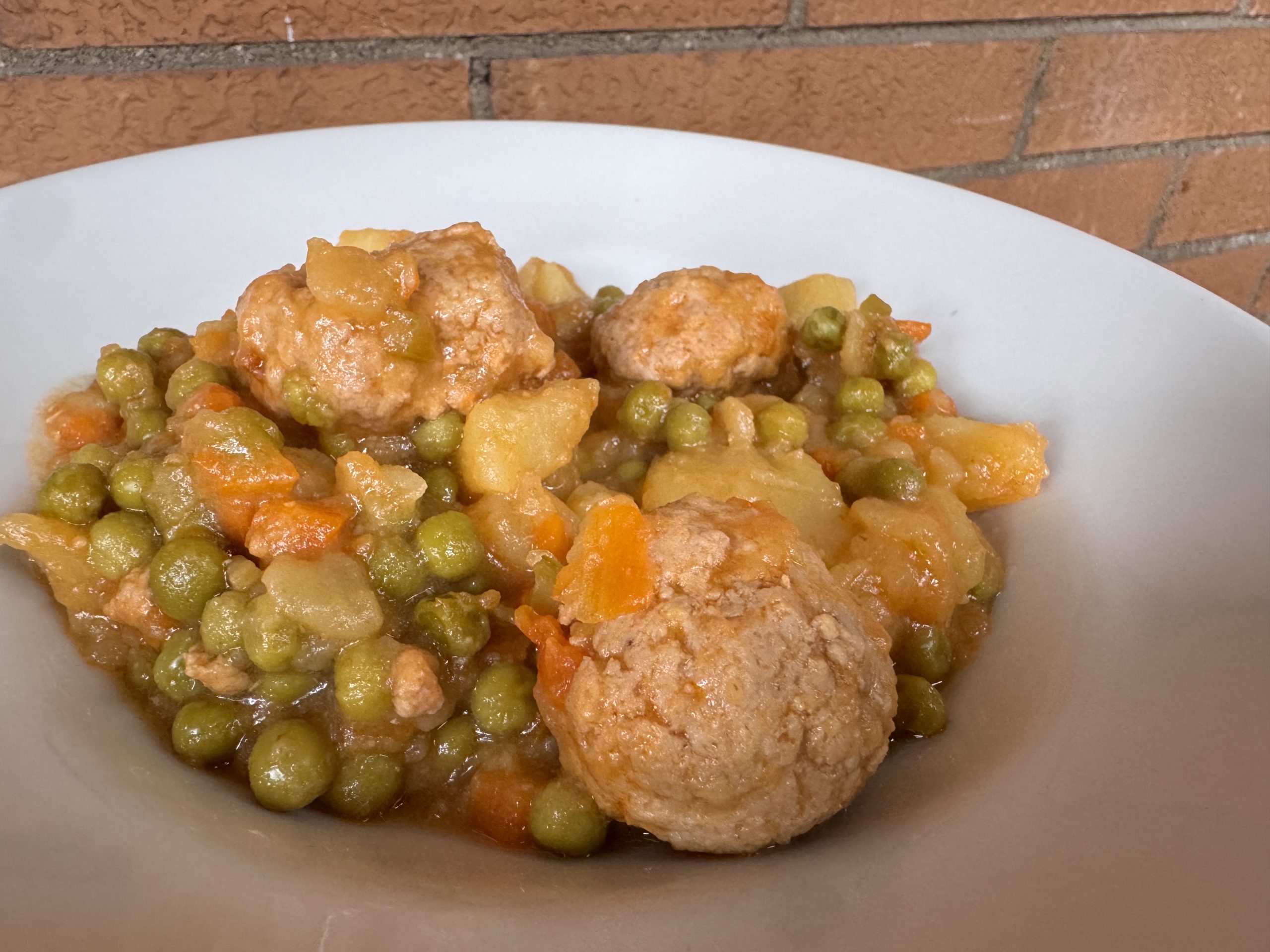 meatballs stew with potatoes and peas